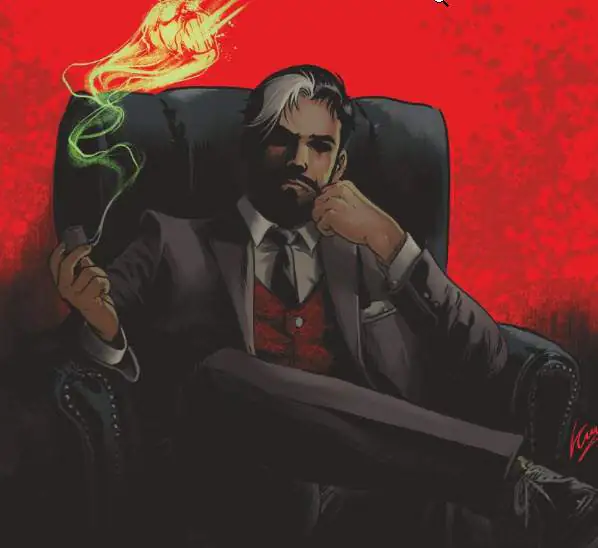 Hombre en traje, fondo rojo, sentado en sillón.